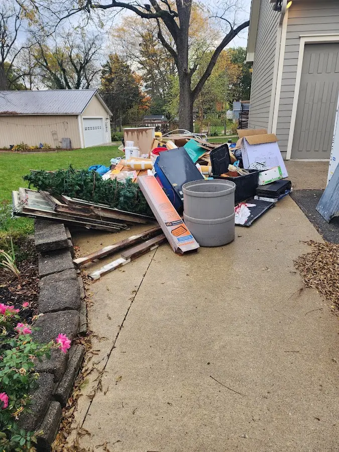 Dumpster being loaded with debris for 30 Yard Dumpster Rental in Belville